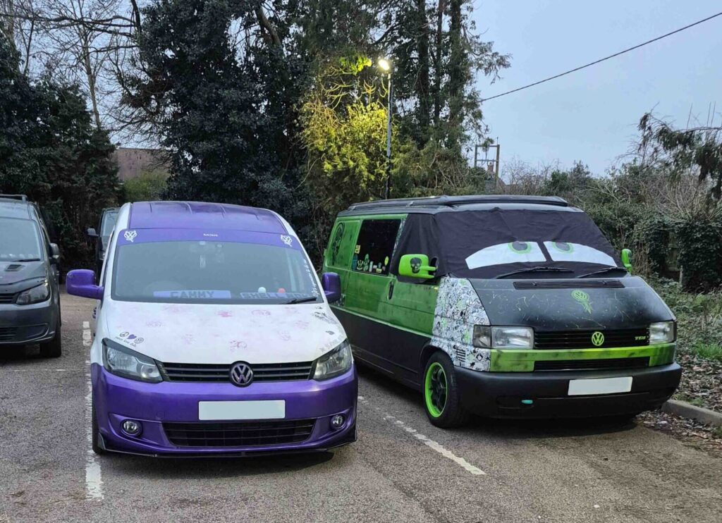 VW T4 Elain parked next to VW Caddy camper van on a quiet road