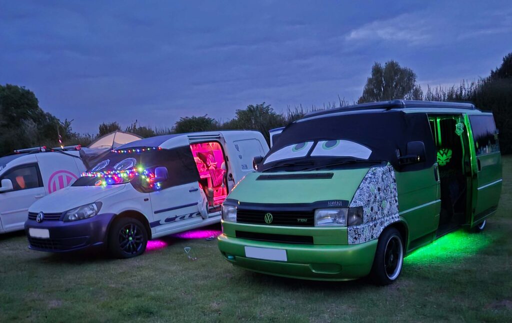 Dan's VW T4 Campervan Story Elain Midlands Dub Club and Real Van Life 4 VW T4 Elain and VW Caddy camper with LED lighting at night during a VW meet