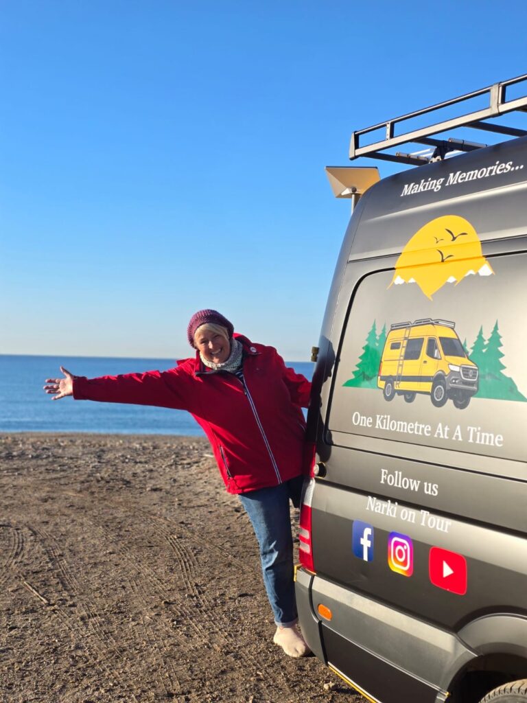 Van Life Europe: Mark, Nikki & Sid’s Journey | Choosing Freedom on the Road 9 Mercedes Sprinter camper van exterior with Narki on Tour branding