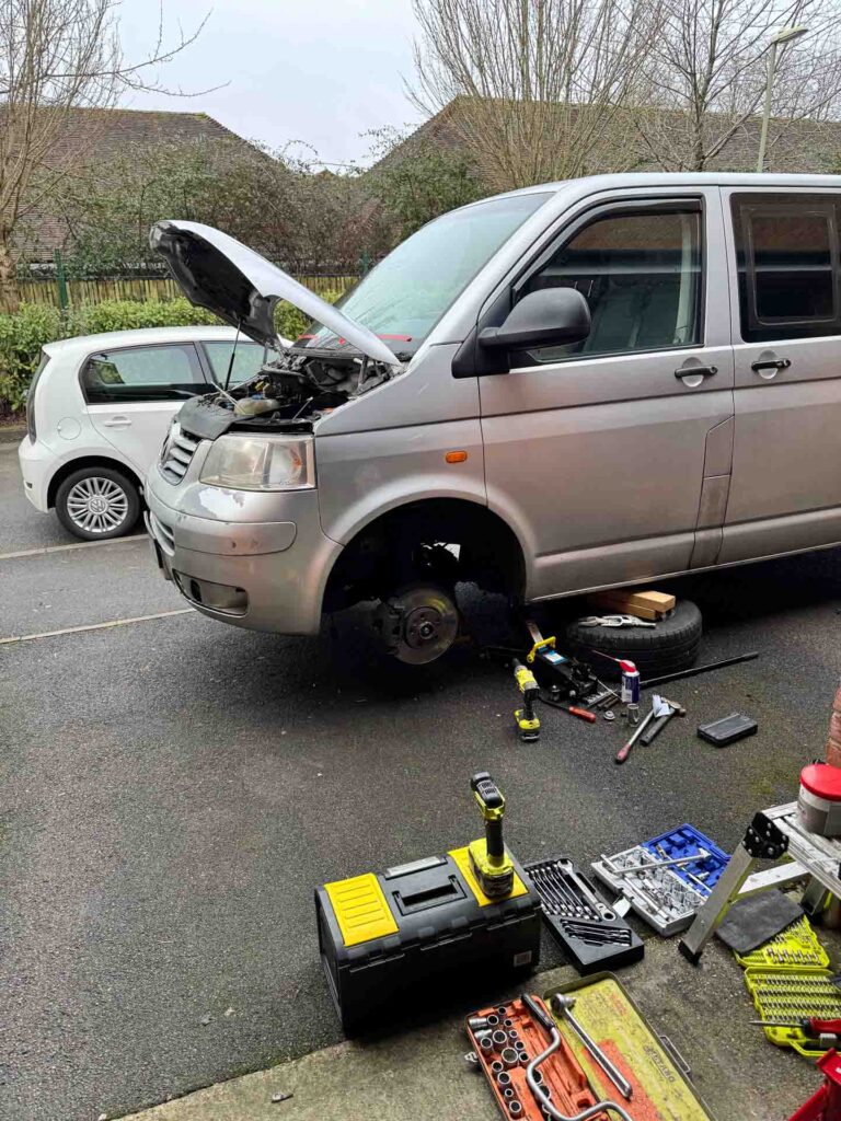 Garage life VW culture – VW T5 Transporter being repaired on a driveway with tools laid out