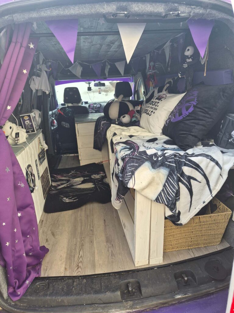 nterior of VW Caddy Maxi camper build with pull out bed and storage