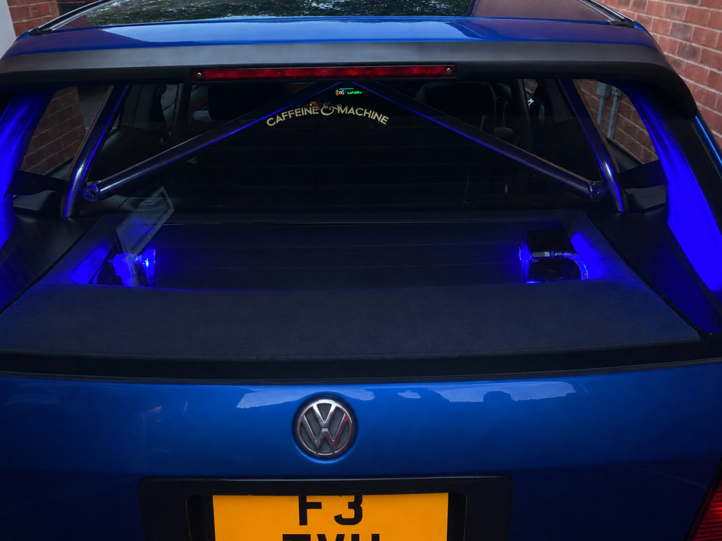 Built, Not Bought: The Story Behind Luke's Modified Mk3 Golf 5 Rear view of a blue Volkswagen Mk3 Golf showing custom air ride installation, rear strut brace and blue illuminated components.