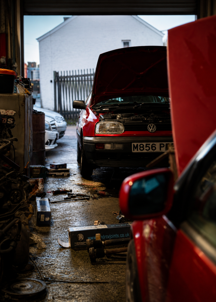 Ben’s red Volkswagen Golf Mk3 Gertrude being worked on in the garage