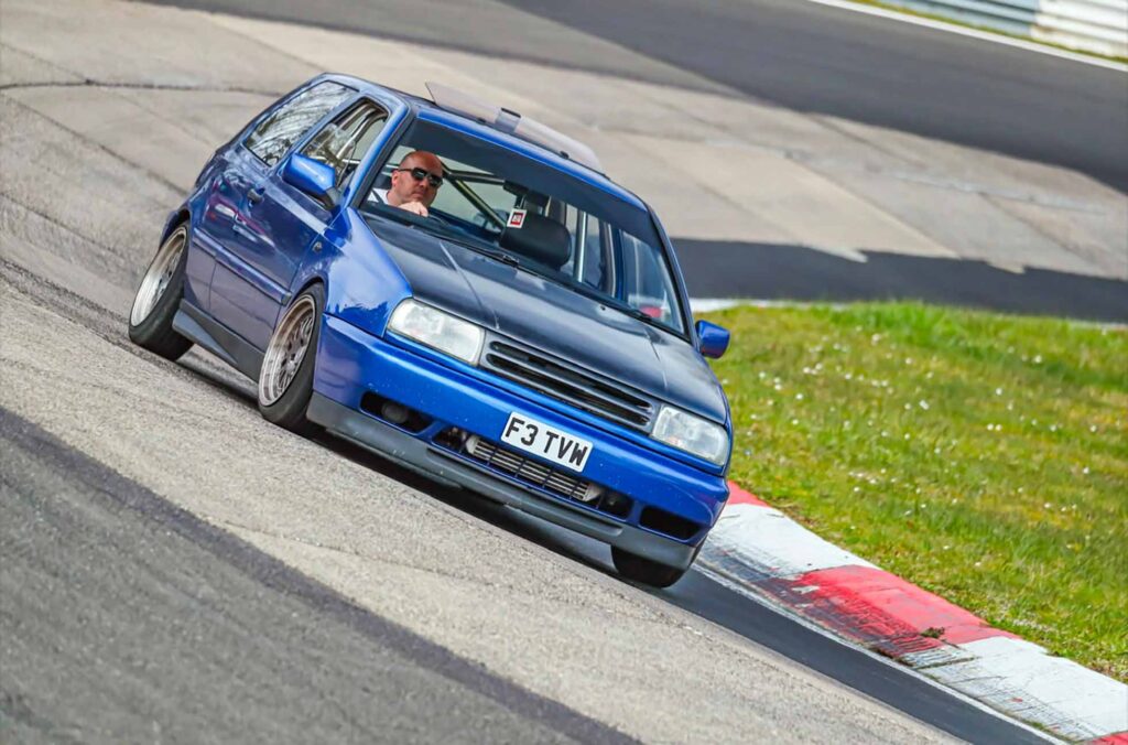 Built, Not Bought: The Story Behind Luke's Modified Mk3 Golf 7 Luke's modified Mk3 Golf driving on the Nürburgring during his European road trip